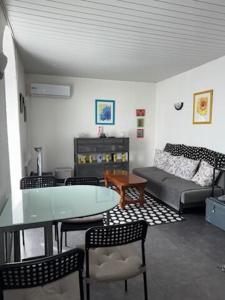 a living room with a table and a couch at ASM rugby in Cébazat