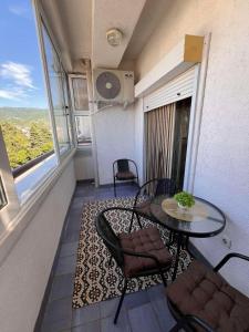 a small balcony with a table and chairs in a room at Sofi Central Apartment in Ohrid