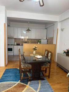 a dining room with a table and chairs and a kitchen at Sofi Central Apartment in Ohrid +7 photos