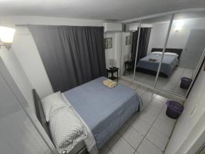 a bedroom with a bed and a mirror at Above The Plaza 4 (6 guest) in Rincon