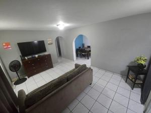 a living room with a couch and a flat screen tv at Above The Plaza 4 (6 guest) in Rincon