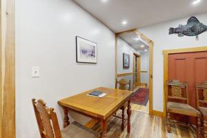 a dining room with a wooden table and chairs at 2-story apartment steps from the harbor & downtown in Boothbay Harbor