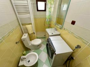 a small bathroom with a toilet and a sink at Villa Leo in Bar +17 photos