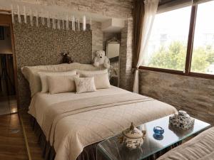 a bedroom with a large bed with a teddy bear on it at Villa Leo in Bar