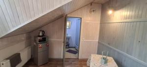 a small room with a staircase in a house at Guest House Mansarda in Yaremche