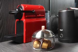 a red toaster sitting on a counter next to a container of food at D&C Premium Suites in Pefkochori
