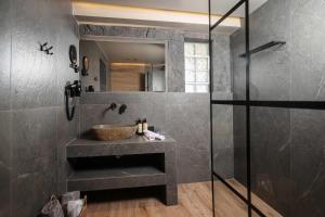 a bathroom with a sink and a glass shower at D&C Premium Suites in Pefkochori +24 photos