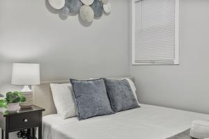 a white bedroom with a bed and a window at Cozy 4BR 2BA Worth Home in Worth +22 photos