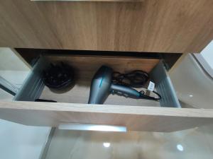 a drawer in a cabinet with a charger and a cord at Barcelos Habadia da Loja in Lijó