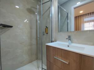 a bathroom with a sink and a shower at Barcelos Habadia da Loja in Lijó +26 photos