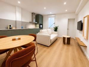 a living room with a table and a white couch at YBH Ocean Boutique in Vigo