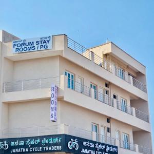 a building with a sign on top of it at Forum Stay in Mysore