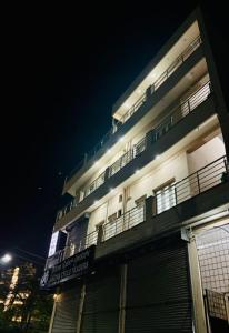 a building with balconies on the side of it at night at Forum Stay in Mysore
