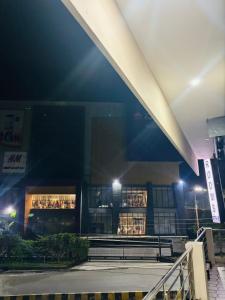 a building with lights in front of it at night at Forum Stay in Mysore +3 photos