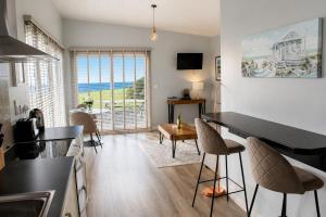 a kitchen and living room with a view of the ocean at Dunmore East Ocean View Suite in Dunmore East