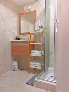 a bathroom with a sink and a mirror and a shower at Iconic Obelisco Studio in Buenos Aires +24 photos