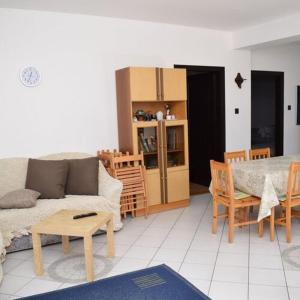 a living room with a couch and a table at Andrea Apartman in Siófok +16 photos