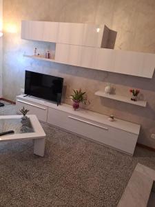 a living room with a flat screen tv on a cabinet at Il sorriso di Giuseppina in Bronte +4 photos