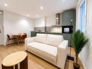 a living room with a white couch and a table at YBH Ocean Boutique in Vigo