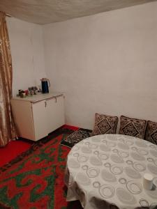 a room with a table and chairs in a room at Чырак in Ak-Osten