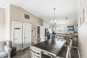 a dining room and kitchen with a table and chairs at Escape OBX in Kitty Hawk