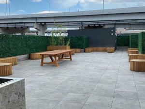 a patio with a wooden table and benches at Eleven48 Hotel in New Orleans
