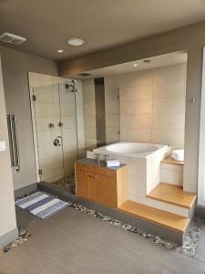 a large bathroom with a tub and a shower at Bowen Island Ocean Retreat in Bowen Island +30 photos