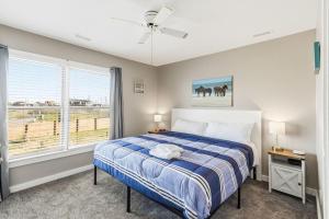a bedroom with a bed and a window at Escape OBX in Kitty Hawk +57 photos