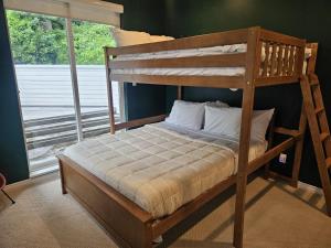 a wooden bunk bed in a room with a window at Bowen Island Ocean Retreat in Bowen Island