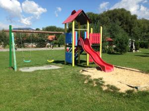 a playground with a slide in a park at Tatralandia-Liptov Chatky in Liptovský Mikuláš
