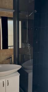 a bathroom with a sink and a toilet and a mirror at Villa Brodetto, Sveti Stefan in Pržno +17 photos