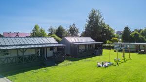 a yard with two houses and a playground at Domki u Basi - 250m do Plaży - Idealne dla Rodzin in Karwia