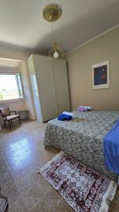 a bedroom with a bed and a rug on the floor at Casina Da Vinci in Vinci