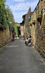 a group of people sitting on benches in an alley at Casina Da Vinci in Vinci