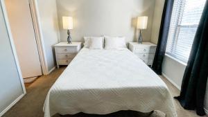 a bedroom with a white bed with two night stands at 10 Min to Downtown - Pet-friendly, TV with Parking in Robstown +16 photos