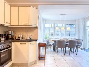 a kitchen and dining room with a table and chairs at Kinnekulle 1 in Groß Kirr