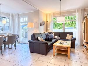 a living room with a couch and a table at Kinnekulle 1 in Groß Kirr