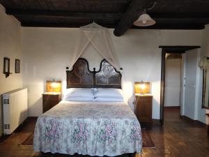 a bedroom with a large bed with a canopy at CASALE SPOLETO in Spoleto +59 photos
