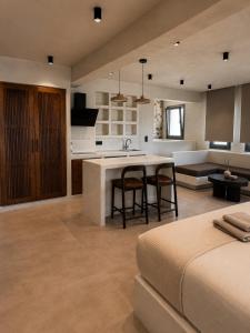 a kitchen and living room with a table and chairs at Ethos Suites in Agios Prokopios