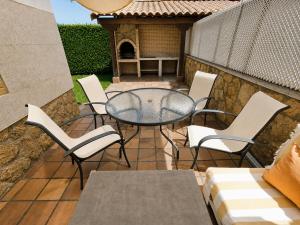 a patio with a table and chairs and a grill at Casa Turística la Almunia in Castellanos de Moriscos