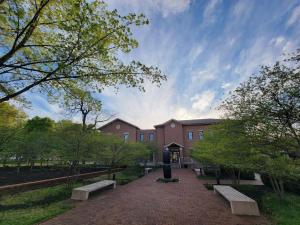 a brick building with benches in a park at Robin's Egg, Private Downtown, Pet-Friendly Gem in Columbus