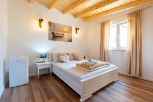 a white bedroom with a bed and a window at Villa Bali Oasis Grand Wellness in Stolac +90 photos