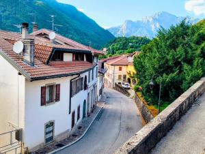 a street in a town with mountains in the background at Casa Pal Piccolo - Apartment with garage for bikes and fast wifi in Paluzza