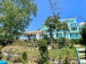 a hotel with a building in the background at Europe Holiday Apartments First Sea Line Coast in Pomorie