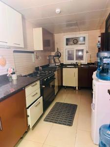 a large kitchen with a stove and a refrigerator at شقة كبيرة مؤثثة بالكامل in Salalah +9 photos