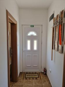 a white door with a sign on it in a hallway at Vuković house - Lake View & Nature in Kuside