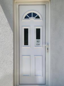 a white door with a sign on it at Vuković house - Lake View & Nature in Kuside