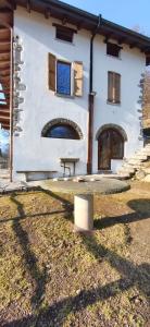a house with a picnic table in front of it at Country Cottage by LePigne World in Ameno