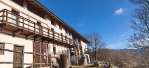 a building with wooden balconies on the side of it at Country Cottage by LePigne World in Ameno