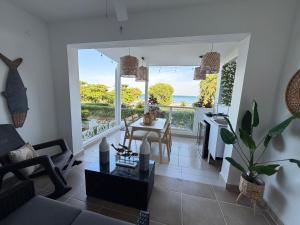 a living room with a view of the ocean at Villas del Mar PTY in Río Hato